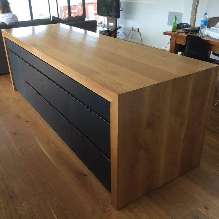 Bespoke oak kitchen island with black drawer fronts and a solid oak waterfall top