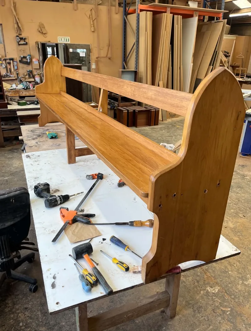 Church pew being restored on the bench in the D.J. Morrison workshop, Christchurch