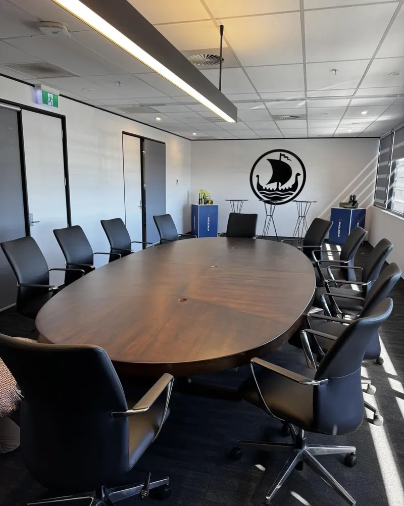 Skellerup boardroom table after restoration, deep polished timber top in the fitted boardroom